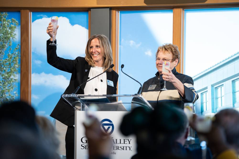 Lynn Blue toasting on stage at the Lynn M. Blue Connection Naming Ceremony